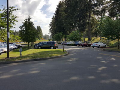 Green grass and trees surround the parking lot