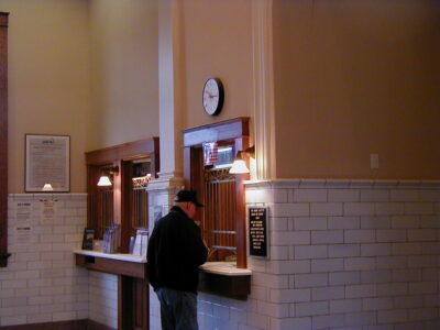 A person at the ticket counter at the Centralia Station.