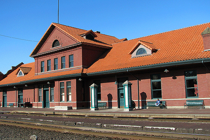 The outside of the Centralia Station highlighting the brick walls and red Spanish tile roof.