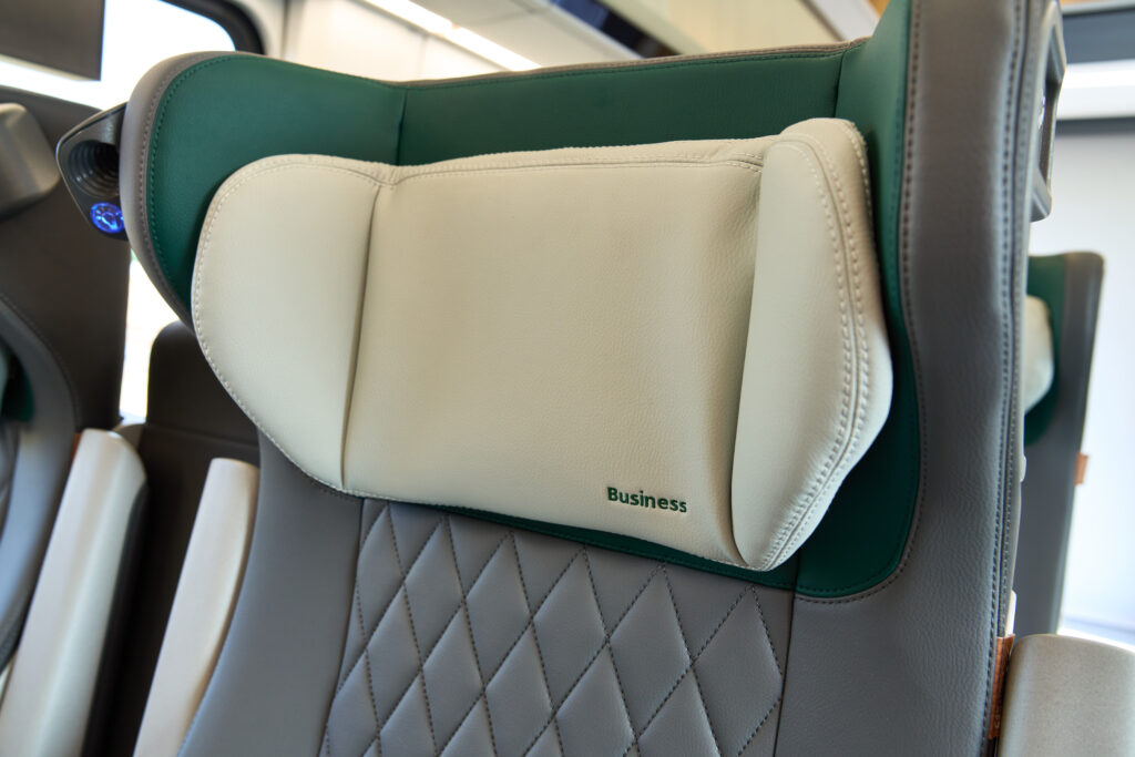 Close up photo of a cushy headrest on a seat in the Business Car.